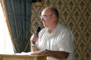 Ciaran Mulgrew speaks at the Social Care Awards from a podium.