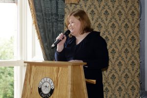 Tracy Reid, Interim Executive Director of Social Work, speaks at the awards from a podium.