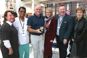 Eddie Kearney pictured with the Mercy Medal and senior Trust staff; Brenda Creaney, Dr Satyavir SInghal, Dr Cathy Jack, Mr Mark Taylor and Bernie Owens.