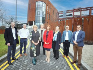 Group photo of staff from Belfast Trust Capital Development team and representatives from partner organisations who worked on the construction of the new maternity hospital outside the building.
