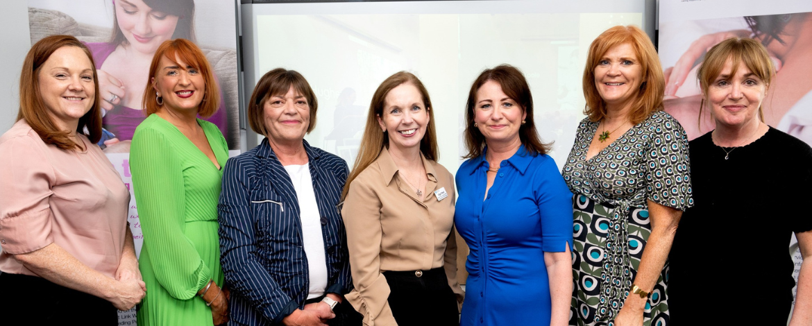 Members of the Health Visiting Service smiling alongside Director of Nursing Olga O'Neill and Interim Chief Executive Maureen Edwards.