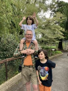 Male carer with his two grandchildren at Family Day at Castle Espie