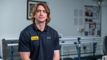 Joe sitting in a Rehabilitation gym